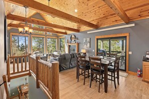 A spacious living area with a fireplace, dining table, and seating. - Your Perfect Black Hills Adventure Starts at The Lodge on High Ridge Trail! (Lead)