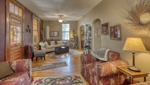 A spacious living room with a fireplace, a sofa set, a coffee table, and a lamp. - Mountain Oasis - private hot tub and game room. (Lead)