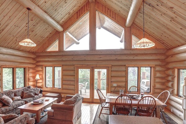 Cozy seating area with a sofa, chairs, and dining table, plus a fireplace for warmth.