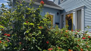 A two-story house with a blue exterior and a yellow front door. - Cozy, Cute, Private Ozark Suite 5 Mins to Hospital (Ozark)