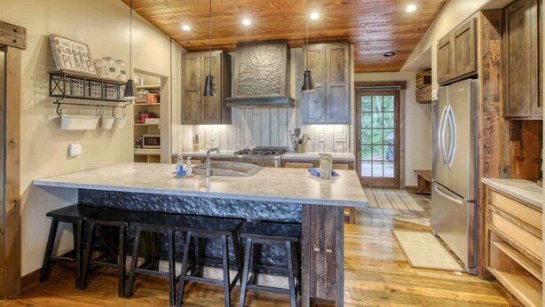 A spacious kitchen with a large island, wooden ceiling, and modern appliances. - Après Powder Haus – Walk to the slopes!  Hot tub, pet friendly and game garage (Lead)