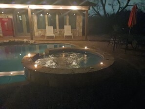 A pool area with two hot tubs and a covered seating area. - Restoration Retreat with Pool and Hot Tub! (Seguin)