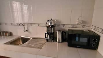 Microwave, coffee/tea maker, cookware/dishes/utensils