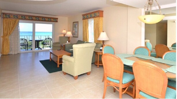 A hotel room with a balcony, a dining area, and a living room. - FLBR 1 BR Condo 1501 - 2 blocks off beach with great Ocean Front Balcony Views. (Fort Lauderdale)