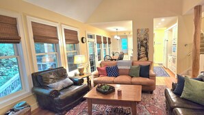 A living room with a sofa, coffee table, and a dining area with chairs and a table. - Private Echota home, great resort amenities, 2car garage, near best attractions (Boone)