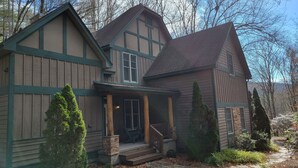 A traditional wooden house with a porch, stone foundation, and a stone chimney. - Private Echota home, great resort amenities, 2car garage, near best attractions (Boone)