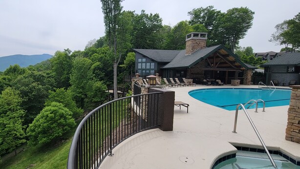 A pool area with a view of mountains, surrounded by lush greenery. - Private Echota home, great resort amenities, 2car garage, near best attractions (Boone)