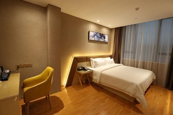 A hotel room with a bed, a desk, a chair, a nightstand, a painting on the wall, and a window with curtains. - Boke Hotel Guangzhou Zhujiang New Town (Guangzhou)