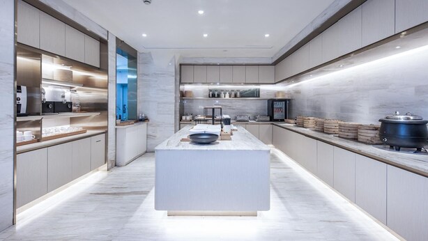 A modern kitchen with a central island, built-in appliances, and a sleek design. - Ji Hotel (Shanghai)