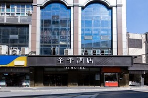 A hotel with a modern facade, large glass windows, and a sign reading "JI HOTEL". - Ji Hotel (Shanghai)