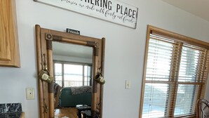 A kitchen with a wooden coffee station, a mirror, and a window with blinds. - Waterfront home (Pelican Lake)