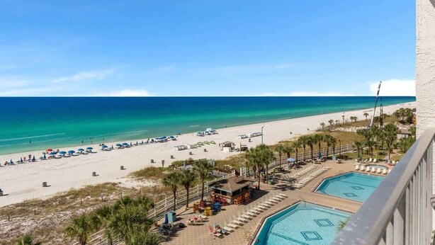 A beach resort with a pool area, beach umbrellas, and a clear view of the ocean. - The Summit 726 - Condo with Spectacular Ocean View (Panama City)