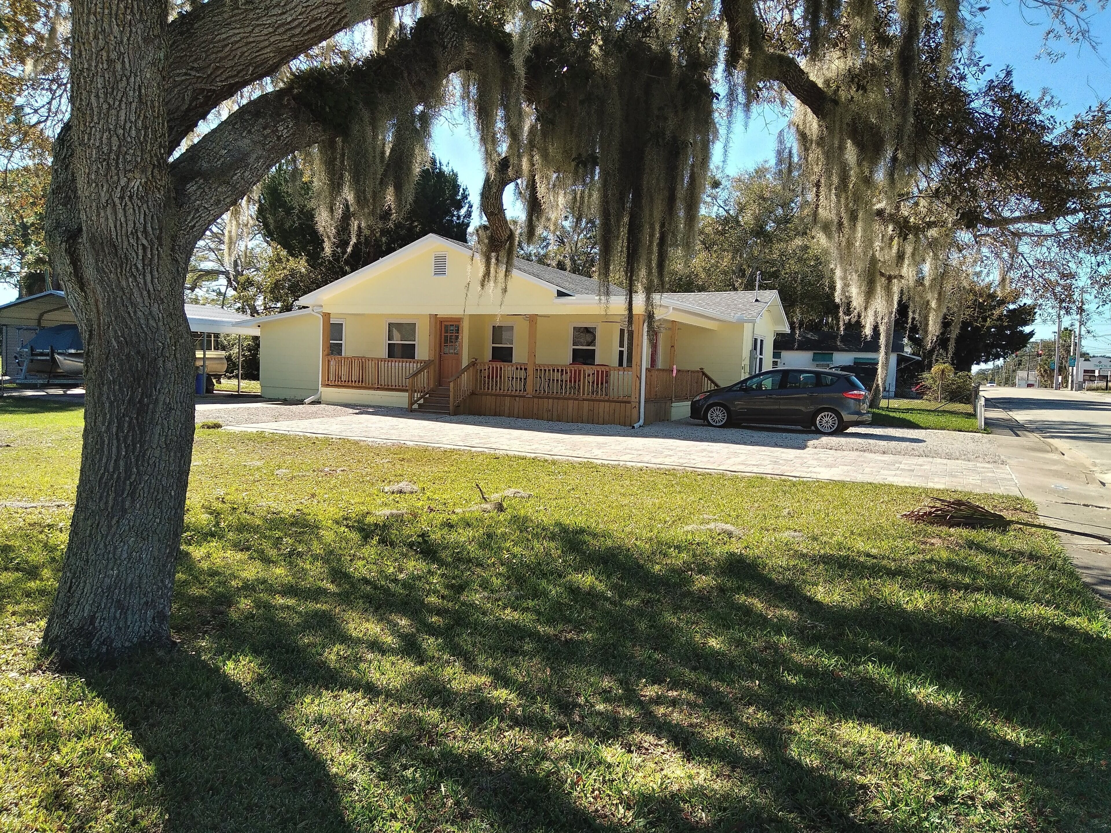 Charming 3 bedroom 2 bath home w/ wraparound veranda on one acre of land.