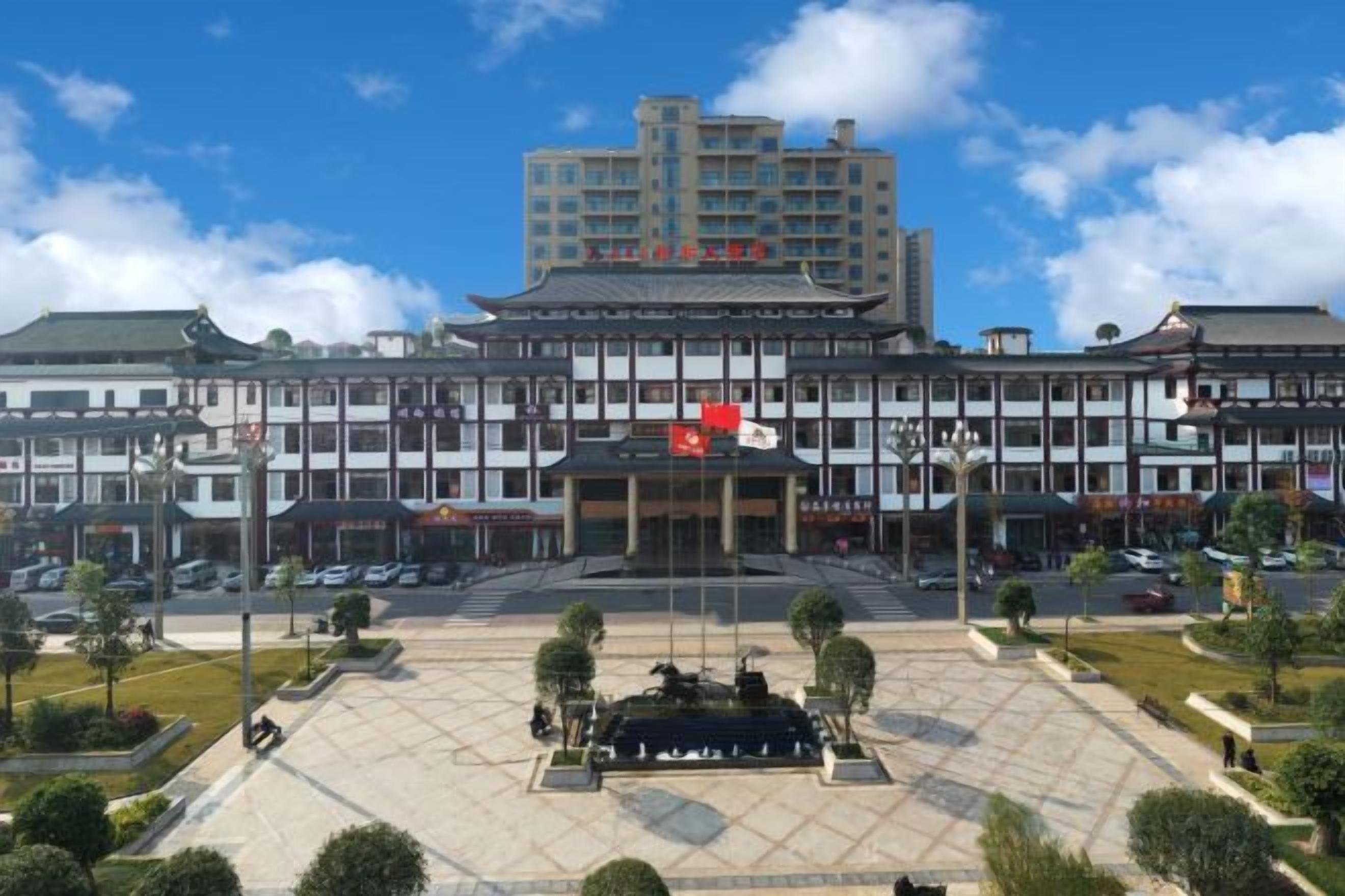 A large building with a central courtyard, multiple floors, and a flag on top.