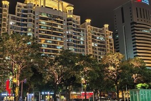 A multi-story hotel with a modern design, featuring balconies and illuminated windows. - Tianze Enjoy Hotel (Fuqing)