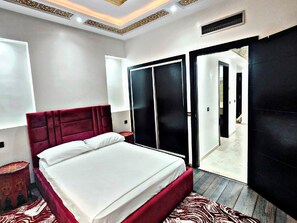 Une chambre moderne avec un grand lit, une armoire et une vue sur le couloir.