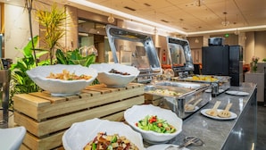 A buffet area with various food options, including salads and hot dishes, in a modern hotel setting. - Shangheng Grand Hotel Panzhihua (Panzhihua)