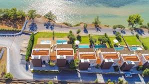 An aerial view of a coastal hotel with multiple buildings, a swimming pool area, and a beach. - Villa Kalma Ena, charming villa, private pool, near Moudania (Gremia Nea Moudania)