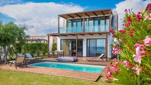 A modern two-story house with a swimming pool, outdoor seating, and lush greenery. - Villa Kalma Ena, charming villa, private pool, near Moudania (Gremia Nea Moudania)