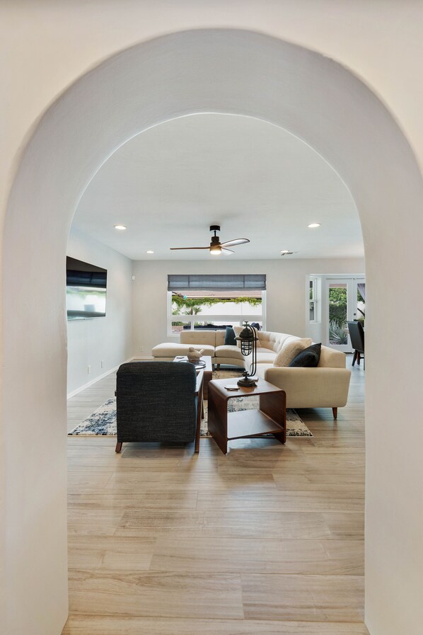 A modern living room with a sofa, coffee table, and a fireplace.