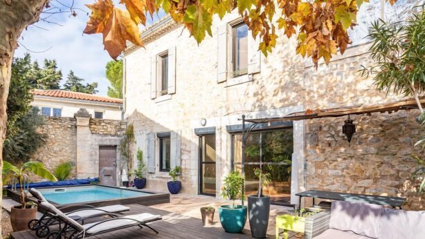 A stone house with a pool, outdoor furniture, and potted plants. - Le Mas Provençal by Interhome (Jonquieres Saint Vincent)