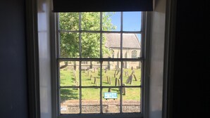 A window with a view of a cemetery. - Stylish Historic Apartment - Sleeps 3 & Parking (Norwich)