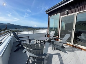 Relax on the deck with a table and chairs, taking in the serene views of the surrounding landscape.