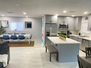 Enjoy cooking and dining in this well-equipped kitchen with a central island and adjacent dining area.