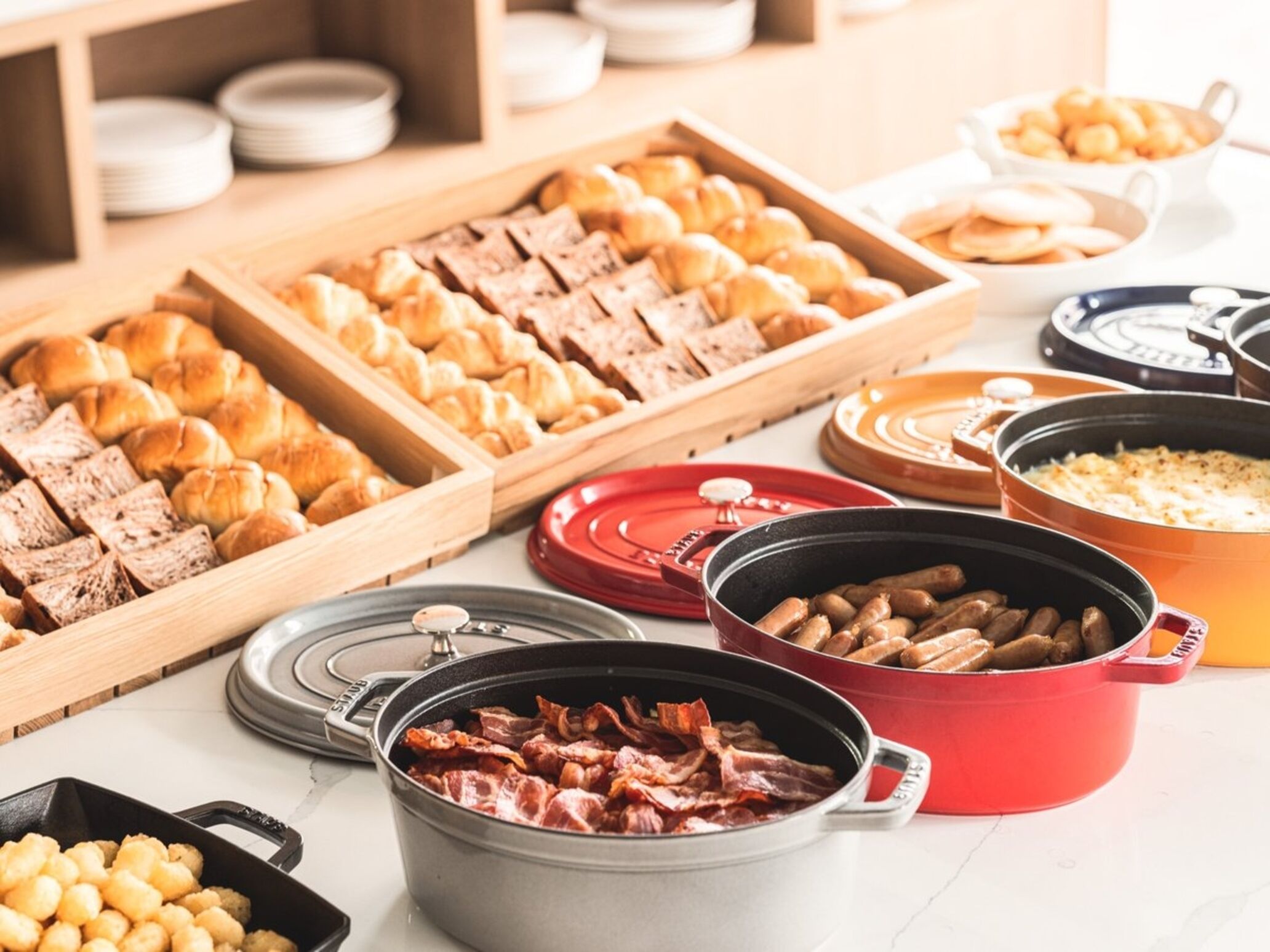 A buffet with various food items including pastries, meats, and vegetables.