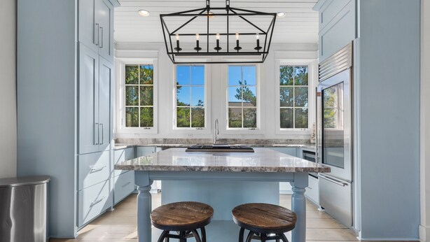 A kitchen with a central island, two bar stools, and a pendant light. - Dejarnette Cottage w/Private Courtyard & Pool | 30A Rosemary Beach | My Beach Getaways (Rosemary Beach)