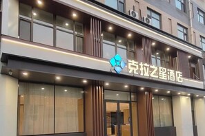 A hotel with a modern facade, large windows, and a prominent logo. - Kela Star Hotel (Shenyang Sujiatun Exhibition Center) (Shenyang)