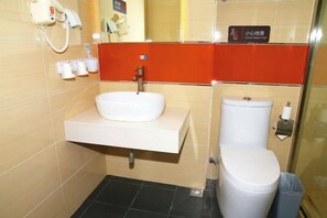 A compact bathroom with a white sink, a toilet, and a hand dryer. - Kela Star Hotel (Shenyang Sujiatun Exhibition Center) (Shenyang)