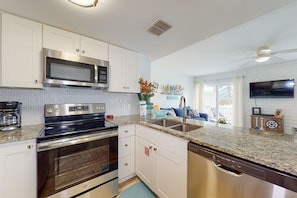 Enjoy cooking in this well-equipped kitchen with a microwave, oven, and dishwasher.