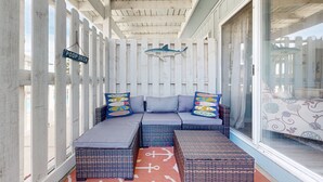 A covered porch with a white fence, a bench with cushions, and a 'POOP DECK' sign. - Ground Floor Condo, Shared Pool, Grills and Boardwalk (Port Aransas)