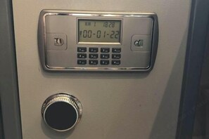 A keypad with a digital display showing the time and date.