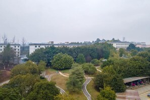A residential area with a winding road, surrounded by trees and buildings. - Gannan Normal University International Academic Exchange Center (Ganzhou)