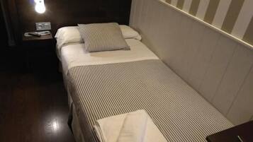 Restful retreat with a striped bedspread and a comfortable bed.