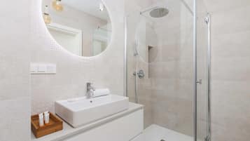 Shower, hair dryer, towels, shampoo