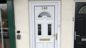 A white door with the number 248, a brass handle, and a small window. - Lovely 2-bed Apartment in Solihull (Solihull)