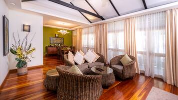 One Bedroom Sea View Suite | Living area | 42-inch flat-screen TV with cable channels, TV