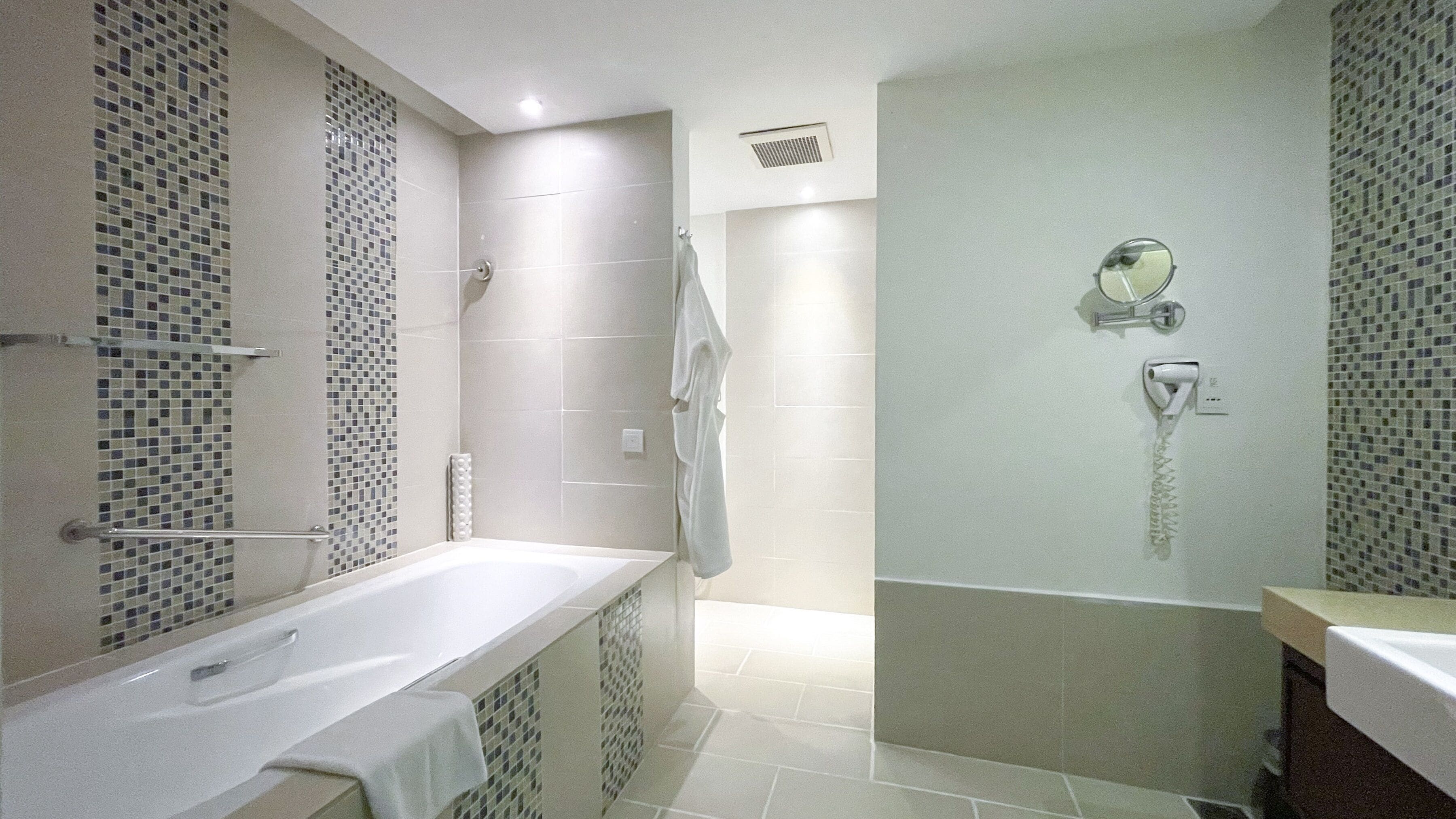 A modern bathroom with a freestanding bathtub, a shower area, and a toilet.