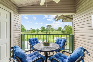 Relax in this outdoor seating area with a round table and four comfortable chairs.