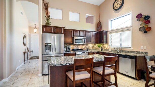 A modern kitchen with granite countertops, stainless steel appliances, and wooden cabinets. - Beautiful Single Story Home in Gated Las Sendas Community with Private Hot Tub  (Mesa)