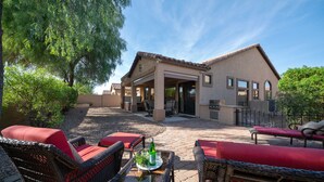 A house with a patio, outdoor seating, and a barbecue area. - Beautiful Single Story Home in Gated Las Sendas Community with Private Hot Tub  (Mesa)