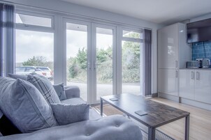 Apartment (1 Bedroom) | Living area | 32-inch flat-screen TV with cable channels, TV