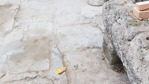 A stone-built structure with a bench and a small table, possibly a courtyard or garden area.