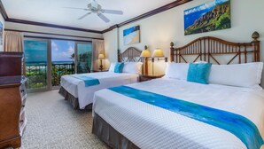 A hotel room with two beds, a balcony with a view, a ceiling fan, and a painting on the wall. - Waipouli Beach Resort Exquisite Beautifully Decorated Extra Large Luxury (Kapaa)