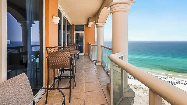 A balcony with wicker furniture, a glass railing, and a view of the ocean. - P3-2002 2B Gulf Front*Sunset Views! (Pensacola Beach)