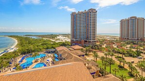 A resort with multiple high-rise buildings, a swimming pool area, and a beach view. - P4-0902 2B Island View Oasis @ Portofino (Pensacola Beach)