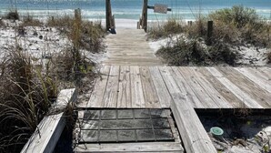 A wooden boardwalk leading to a beach with clear skies. - "Sandy Toes" ON THE SAND! (Destin)